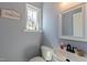 Charming powder room with toilet, pedestal sink, decorative mirror, and bright natural light at 106 Madison Square Ln, Cary, NC 27513