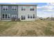 Exterior view of the home's back with a patio and grassy yard space at 108 Ripple Way # 319, Clayton, NC 27520
