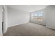 Neutral bedroom with three windows and carpet flooring for a calm, relaxing atmosphere at 108 Ripple Way # 319, Clayton, NC 27520