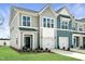 Charming townhome exterior with gray siding, white trim, and well-manicured landscaping at 108 Ripple Way # 319, Clayton, NC 27520