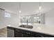 Modern kitchen island with stainless steel sink and white countertop, connects to the open living space at 108 Ripple Way # 319, Clayton, NC 27520