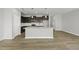 A modern kitchen with an island, dark cabinets, stainless steel appliances, and light countertops at 108 Ripple Way # 319, Clayton, NC 27520