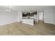 Bright, open living space features hardwood floors and flows into the modern kitchen area with pendant lighting at 108 Ripple Way # 319, Clayton, NC 27520