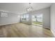 Large living space with hardwood floors, modern light fixture, and sliding glass doors for lots of light at 108 Ripple Way # 319, Clayton, NC 27520