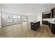 Bright, open living space features hardwood floors, large windows, and flows into the modern kitchen area at 108 Ripple Way # 319, Clayton, NC 27520