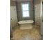 Elegant bathroom featuring a freestanding bathtub with traditional fixtures and tile flooring at 1101 Dovefield Ln, Youngsville, NC 27596