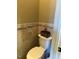 Compact bathroom featuring decorative wall tiles and a toilet with a unique ornamental box at 1101 Dovefield Ln, Youngsville, NC 27596