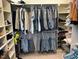 Organized walk-in closet featuring shelving, hanging rods, and a variety of clothing items at 1101 Dovefield Ln, Youngsville, NC 27596