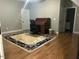 Large room with hardwood floors, a desk, and a decorative area rug at 1101 Dovefield Ln, Youngsville, NC 27596