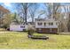 Two-story home with white siding, blue shutters, and a well-maintained front lawn at 1101 Driftwood Dr Dr, Siler City, NC 27344