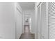 This hallway has white walls, wood floors, white trim, and multiple closet spaces at 1101 Driftwood Dr Dr, Siler City, NC 27344