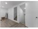 Hallway featuring hardwood floors and access to upstairs and downstairs at 1101 Driftwood Dr Dr, Siler City, NC 27344