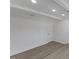 The living room with gray wood floors and white trim is bright and ready for decorating at 1101 Driftwood Dr Dr, Siler City, NC 27344