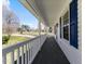 Covered porch with white railings and blue shutters provides a cozy outdoor space at 1101 Driftwood Dr Dr, Siler City, NC 27344