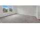 Neutral carpet, white walls, and large windows are in this spacious bedroom at 1128 Centerview Drive, Nashville, NC 27856