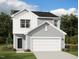 Attractive two-story home featuring light gray siding, white trim and a two-car garage and lush landscaping at 1128 Centerview Drive, Nashville, NC 27856
