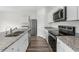 Modern kitchen showcasing granite counters, stainless steel appliances, and white cabinetry at 1128 Centerview Drive, Nashville, NC 27856