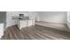 Open-concept living room features plank flooring and a kitchen with white cabinets and stainless appliances at 1128 Centerview Drive, Nashville, NC 27856
