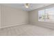 Inviting bedroom with neutral carpet, ceiling fan, and natural light from a large window at 1159 Blue Bird Ln, Wake Forest, NC 27587