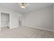 Spacious bedroom with plush carpet, ceiling fan, and en-suite bathroom and walk-in closet at 1159 Blue Bird Ln, Wake Forest, NC 27587