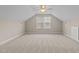 This bright bonus room has neutral walls, carpet and a window at 1159 Blue Bird Ln, Wake Forest, NC 27587