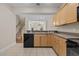 Open kitchen features granite countertops and wooden cabinetry, offering a great space for cooking at 1159 Blue Bird Ln, Wake Forest, NC 27587