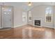 Bright living room with hardwood floors, arched windows, fireplace, and a vaulted ceiling at 1159 Blue Bird Ln, Wake Forest, NC 27587