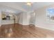 Open concept living room features gleaming hardwood floors and a seamless flow into adjacent kitchen at 1159 Blue Bird Ln, Wake Forest, NC 27587