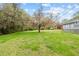Expansive backyard showcasing a large, well-maintained lawn and mature trees, perfect for outdoor activities at 118 Tysor Cir, Graham, NC 27253
