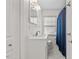 Clean bathroom featuring white fixtures, wainscoting, and neutral colors at 118 Tysor Cir, Graham, NC 27253
