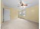 Spacious bedroom with carpet, a ceiling fan, closet, and ample natural light from two large windows at 118 Tysor Cir, Graham, NC 27253