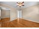 Bedroom with hardwood floors, ceiling fan, sliding door closet at 118 Tysor Cir, Graham, NC 27253
