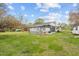 Exterior view of the home, highlighting the deck and a well-manicured backyard on a sunny day at 118 Tysor Cir, Graham, NC 27253