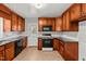Traditional kitchen with wood cabinets, granite countertops, and modern appliances at 118 Tysor Cir, Graham, NC 27253