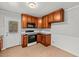Functional kitchen featuring wood cabinets, modern appliances, and tile backsplash at 118 Tysor Cir, Graham, NC 27253