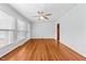 Bright living room featuring hardwood floors, large windows, and a ceiling fan at 118 Tysor Cir, Graham, NC 27253
