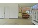 Covered patio featuring a cozy wicker couch with decorative pillows and a view of the lush backyard at 118 Tysor Cir, Graham, NC 27253