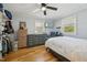 Bedroom featuring hardwood floors, natural light from two windows, a ceiling fan, and a comfortable bed at 1213 Lincoln St, Durham, NC 27701