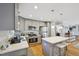 Modern kitchen with stainless steel appliances, a center island, and gray cabinetry at 1213 Lincoln St, Durham, NC 27701
