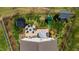 An aerial view of a home with a backyard firepit, playground, trampoline, and well-manicured lawn at 1295 Kerr St, Burlington, NC 27215