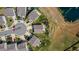 An aerial view showcasing a home in a cul-de-sac, featuring a large backyard with a pond nearby at 1295 Kerr St, Burlington, NC 27215