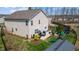 Backyard view showcasing a patio with outdoor furniture, a lush lawn, and a privacy fence at 1295 Kerr St, Burlington, NC 27215