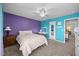 Stylish bedroom with teal and purple walls, carpet, ceiling fan, and vanity at 1295 Kerr St, Burlington, NC 27215
