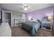 Bedroom featuring gray and lavender walls, carpet, and two storage shelves at 1295 Kerr St, Burlington, NC 27215