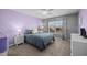Comfortable bedroom featuring a large window, soft lighting, and gray and lavender walls at 1295 Kerr St, Burlington, NC 27215