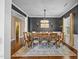 Formal dining room with a modern chandelier, ample seating, and dark accent wall at 1295 Kerr St, Burlington, NC 27215