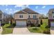 Charming two-story home featuring a manicured front yard and a two-car garage at 1295 Kerr St, Burlington, NC 27215