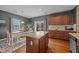 Eat-in kitchen featuring granite island, modern cabinetry, and a sliding glass door to the yard at 1295 Kerr St, Burlington, NC 27215