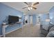 Comfortable living room with a large TV, ceiling fan, and doorways to other areas of the house at 1295 Kerr St, Burlington, NC 27215