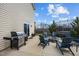 A spacious patio with a BBQ grill, ideal for outdoor cooking and relaxation with a view of the trampoline and backyard at 1295 Kerr St, Burlington, NC 27215